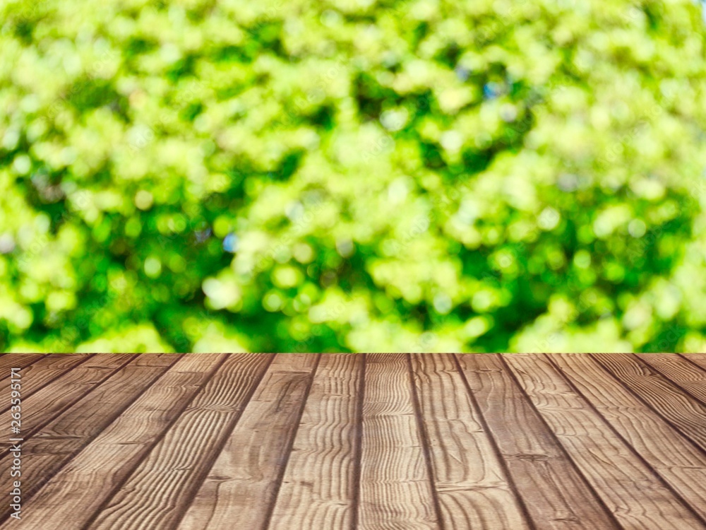 Products shelves and advertisements are wooden floors. The background is green from the nature of the tree (blurred image)