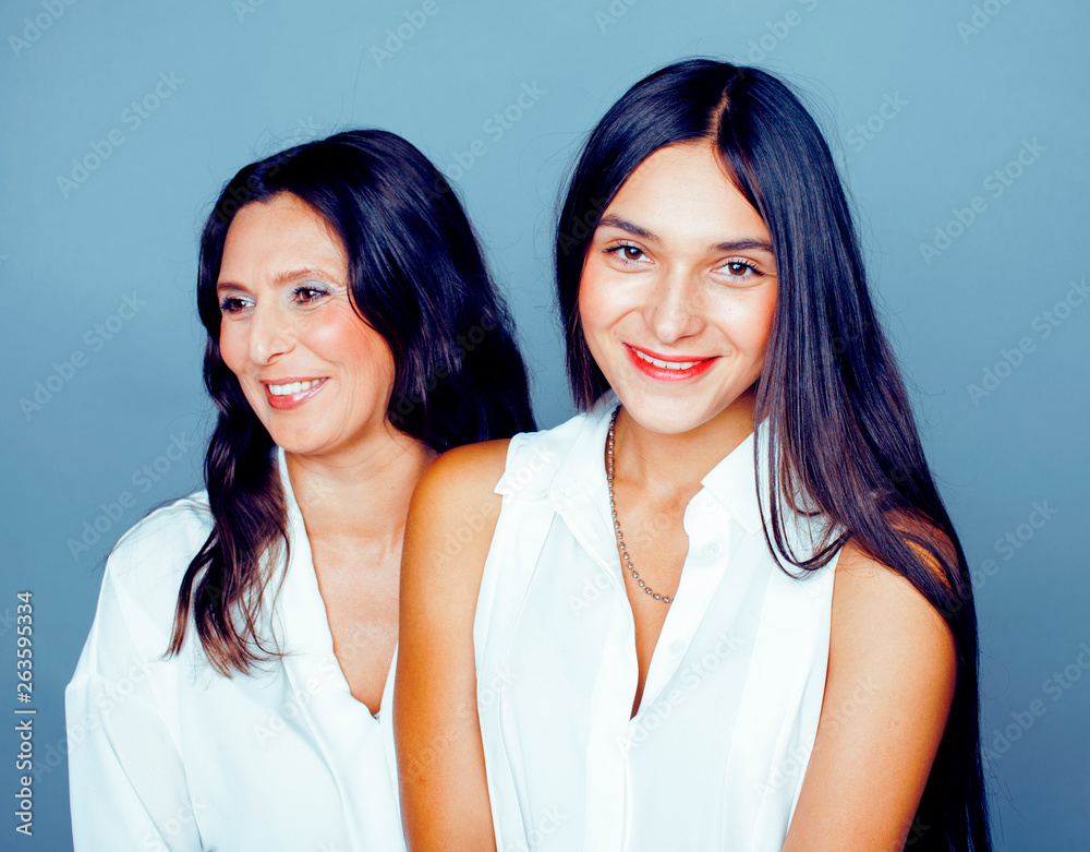 cute pretty teen daughter with mature mother hugging, fashion style brunette, lifestyle people concept close up cute pretty teen daughter with mature mother hugging, fashion style brunette, lifestyle people concept close up