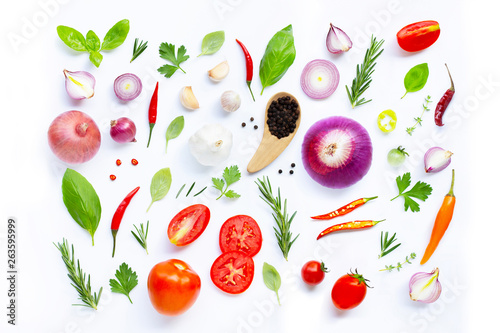 Various fresh vegetables and herbs on white background.