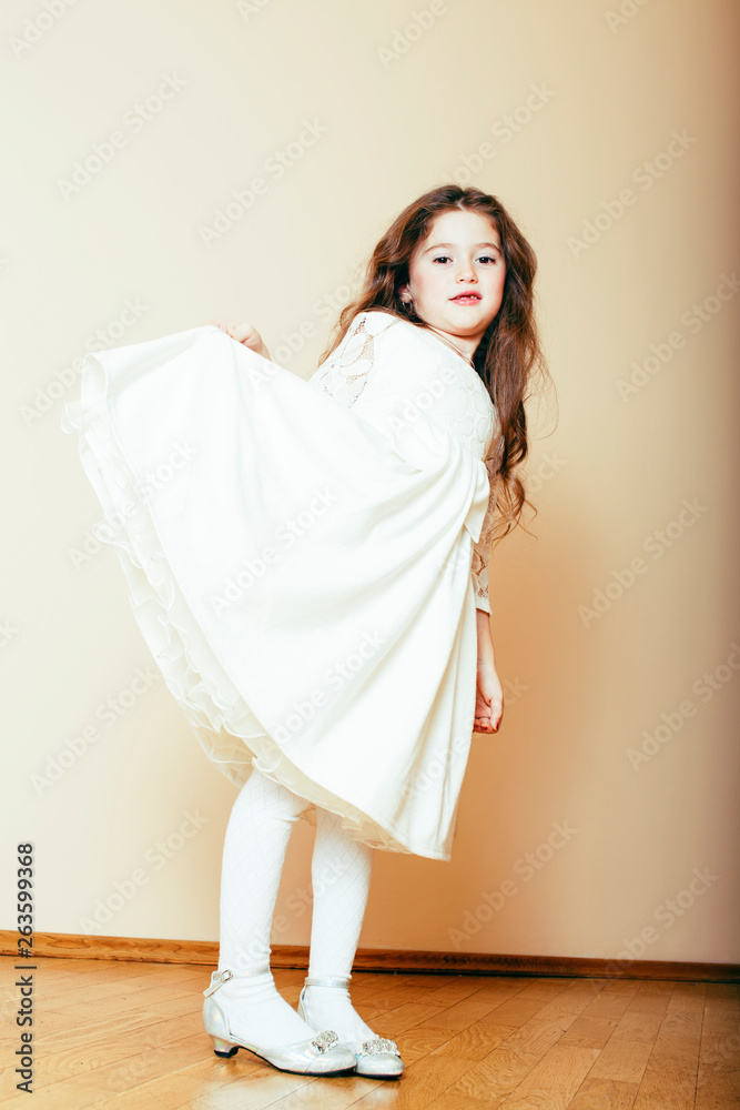 little cute girl with long curly hair posing cheerful on white background, lifestyle people concept little cute girl with long curly hair posing cheerful on white background, lifestyle people concept