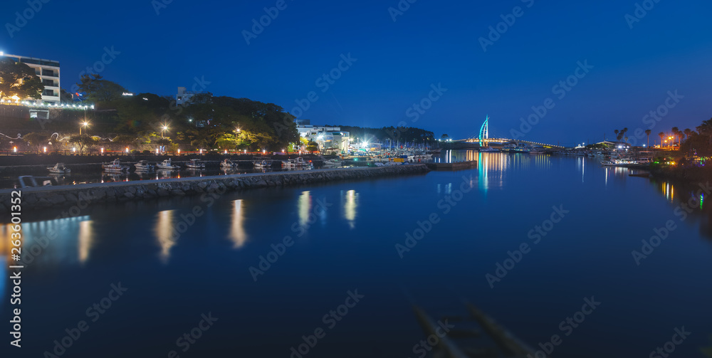 Bright night landscape, bridge in Seogwipo-si  Jeju Island, South Korea. Night illumination, long exposure