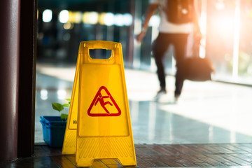 Sign showing warning of caution wet floor at airport