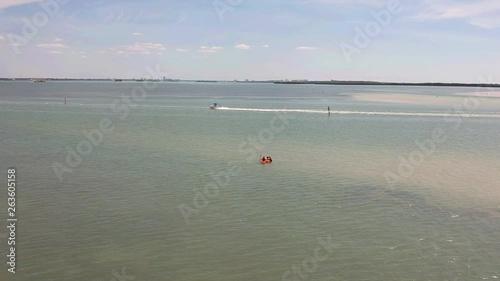 Island fun. This is part of a 21 clip collection of boats, island fly overs, wave runners, paddle boarders, canoes and more. Smooth buttery shots of sun island adventures in Tampa Florida. photo