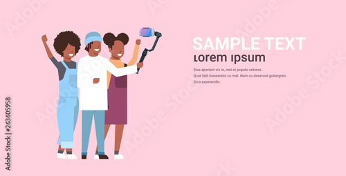 people using 3-axis gimbal stabilizer selfie stick for smartphone happy african american man and women standing together taking photo on smart phone camera horizontal full length