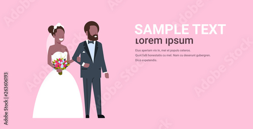 newlyweds just married african american couple standing together bride and groom in love wedding day concept pink background copy space full length horizontal flat