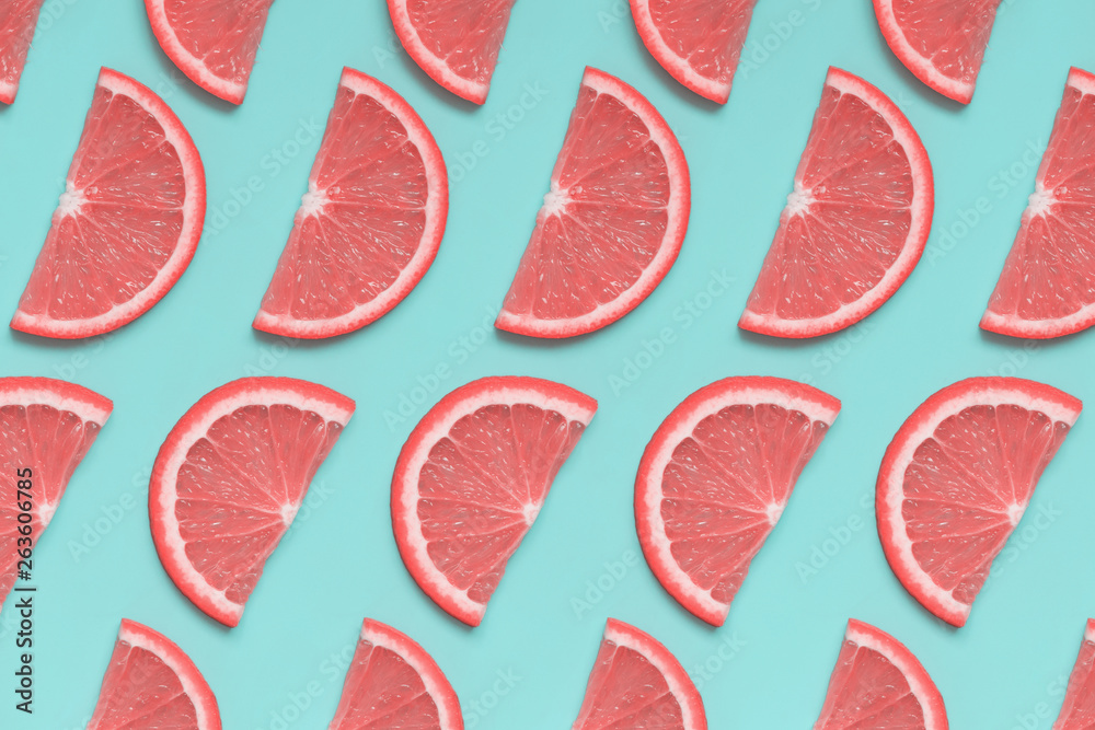 Pink grapefruit isoetric pattern on pastel blue background. Minimal summer fruit concept, pop art style. Flat lay, top view. Pink grapefruit isoetric pattern on pastel blue background. Minimal summer fruit concept, pop art style. Flat lay, top view.