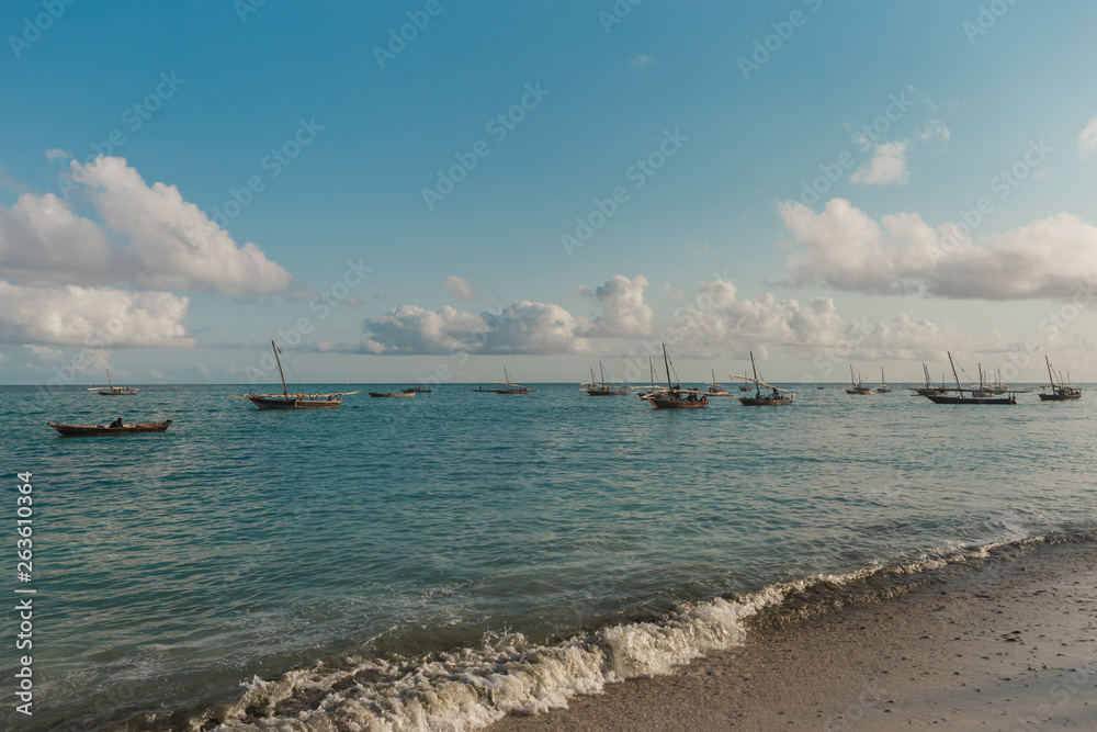 Summer landscape. Wooden old fishing ships at sunrise near the shore