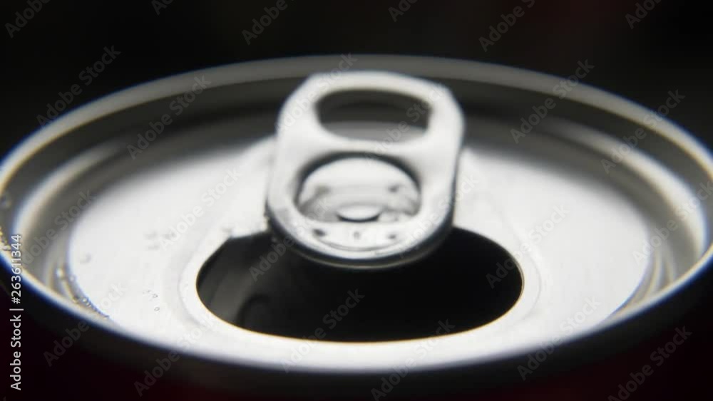 top view of white man open red can of soda or beer. unhealthy eating. hand opening. Slow motion video medium extreme close up high angle telephoto lens audio sound of the opening drink top view of white man open red can of soda or beer. unhealthy eating. hand opening. Slow motion video medium extreme close up high angle telephoto lens audio sound of the opening drink