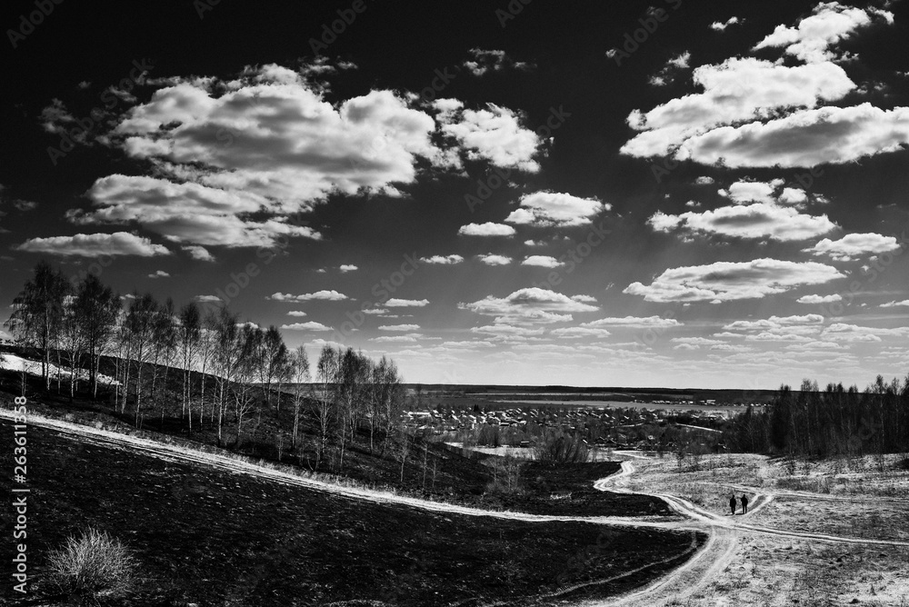 spring landscape with clouds, road and people