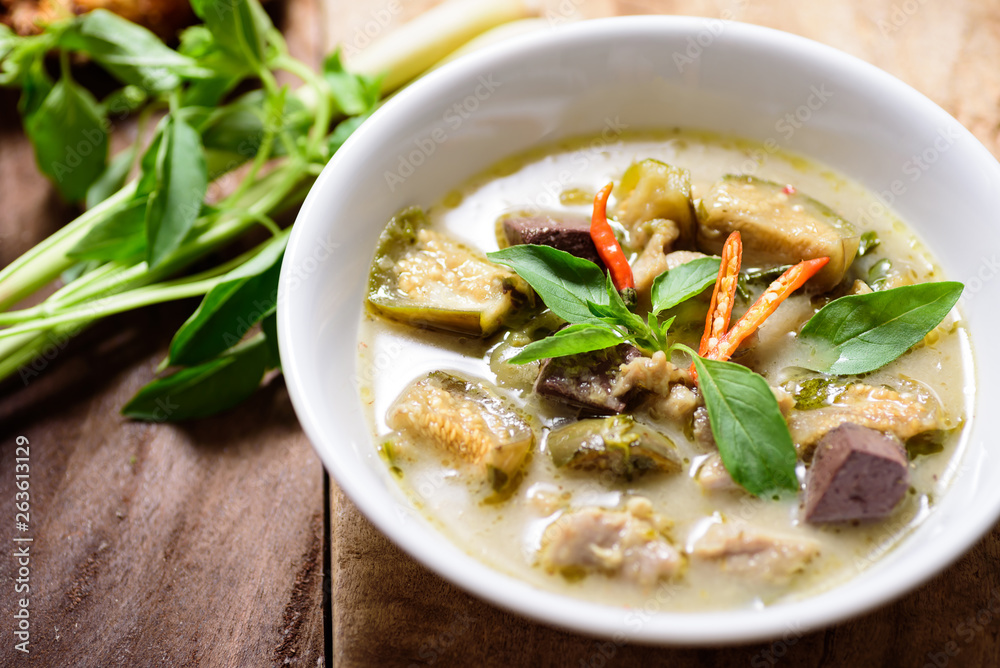 Thai green curry chicken (Kang Keaw Wan Kai) in a bowl on wooden, Thai food Thai green curry chicken (Kang Keaw Wan Kai) in a bowl on wooden, Thai food