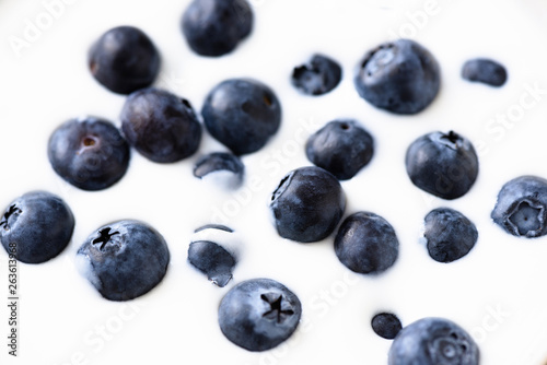 Yogurt with blueberries as background, closeup view