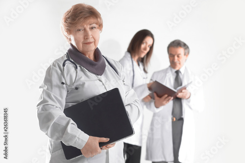 female doctor therapist with laptop on blurred background of colleagues