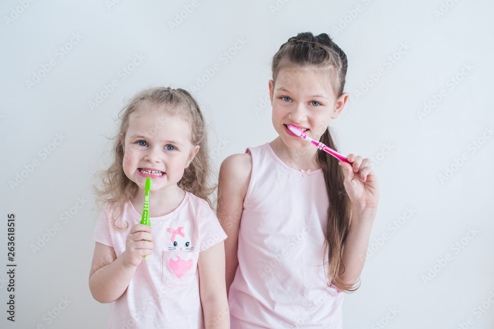 Two Cute pretty little child brushing teeth Two Cute pretty little child brushing teeth