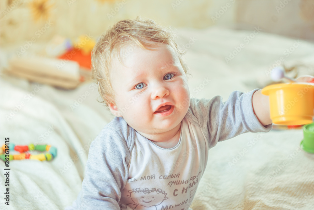 Fototapeta premium The child plays on the bed