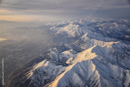 Obraz na płótnie Aerial view from airplane of the Wasatch Front Rocky Mountain Range with snow capped peaks in winter including urban cities of Provo, Farmington Bountiful, Orem and Salt Lake City. Utah. United States w salonie