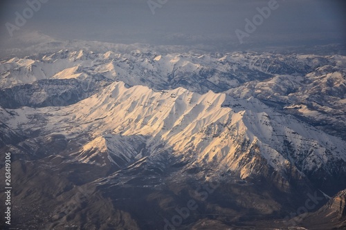 Aerial view from airplane of the Wasatch Front Rocky Mountain Range with snow capped peaks in winter including urban cities of Provo, Farmington Bountiful, Orem and Salt Lake City. Utah. United States © Jeremy