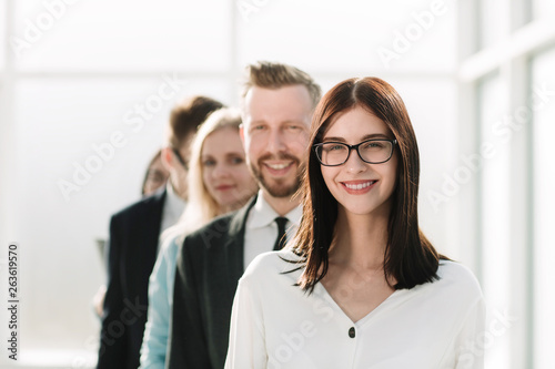 close up. young businesswoman standing in front of the business team