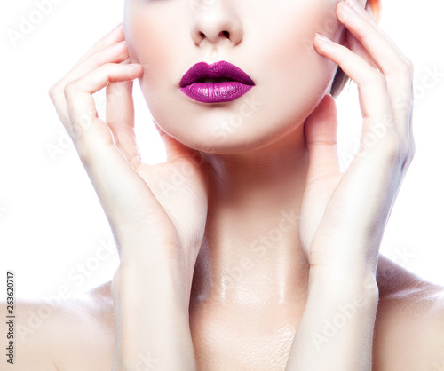 Woman beauty part of face, hands and body. Purple lips bright make-up, clean skin. Isolated. White background