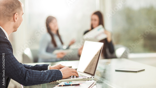 financial managers working on laptop with financial data at the workplace in a modern office