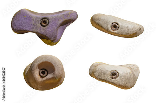 Set of grips different colors and shapes for climbing wall isolated on white background