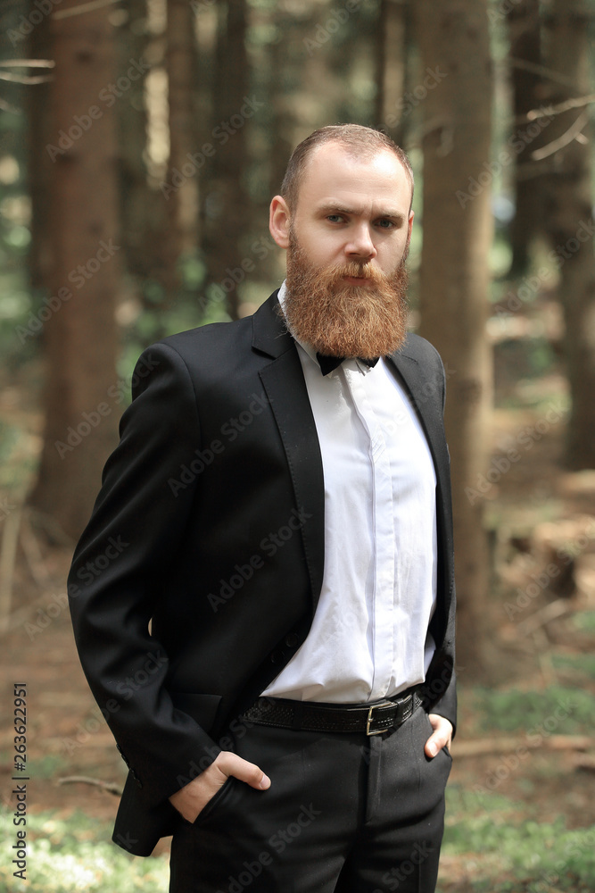 portrait of a successful businessman on a walk in the woods portrait of a successful businessman on a walk in the woods