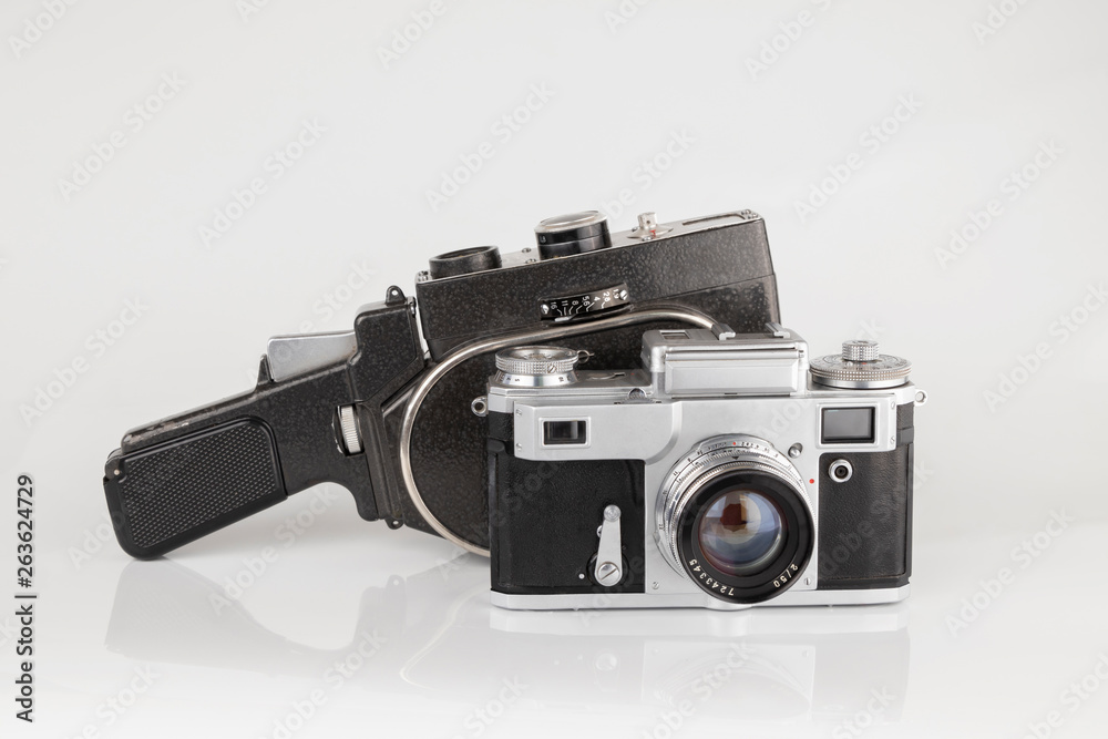 Old vintage photo and video camera on a white background