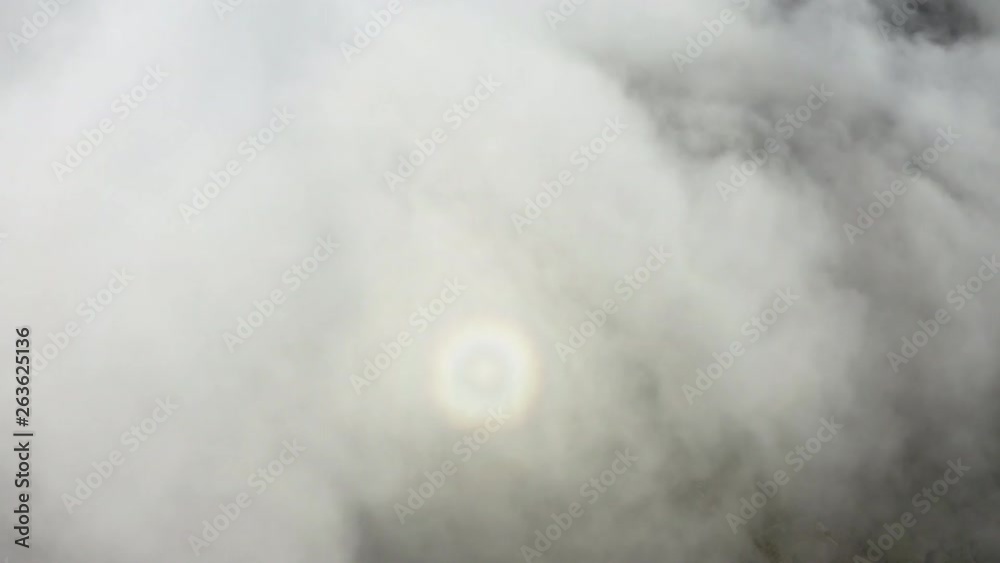 Aerial view, flying trough the clouds in a low speed and creating a glory halo on the clouds whilst flying over them