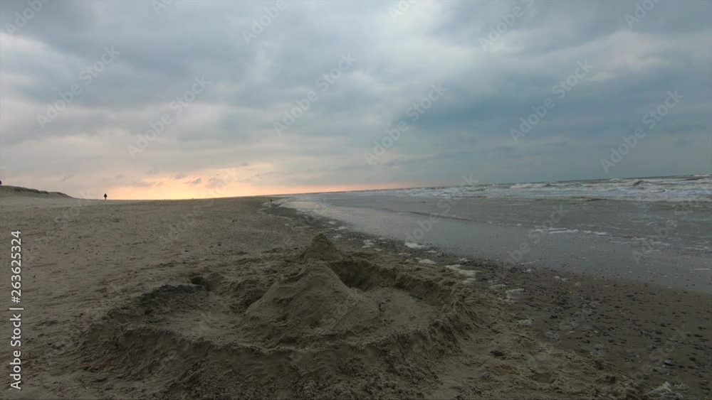 Sand Castle on the ocean at the sunset on a windy cold day Sand Castle on the ocean at the sunset on a windy cold day