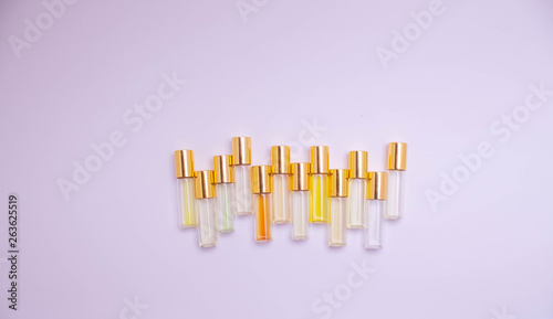 perfume glass tester vials of different kinds on light background. Perfume testers for scent recognition. perfume sample.