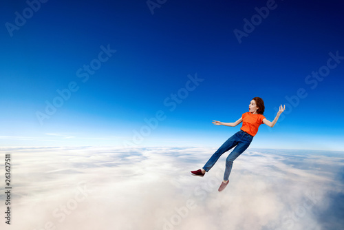 Young woman failed and falling down in clouds sea. © Dmitrii Kotin