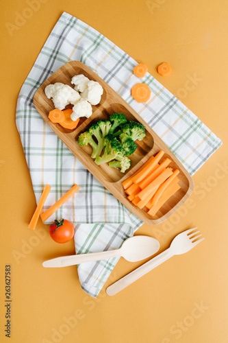 Diet concept. Wooden plate with vegetables  on colored backround