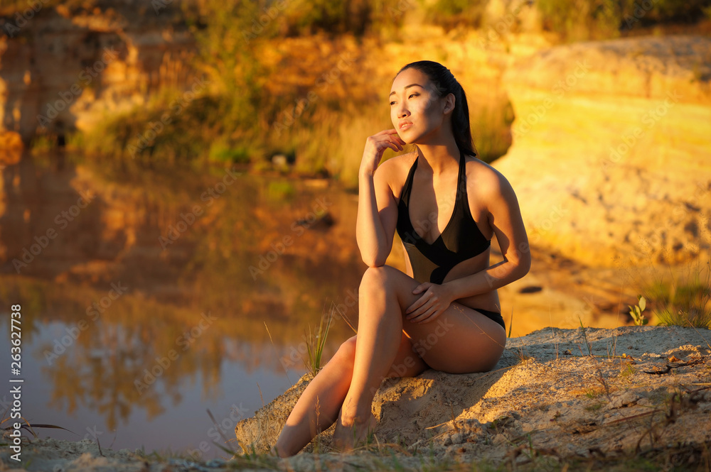 Young asian woman in bikini on sand