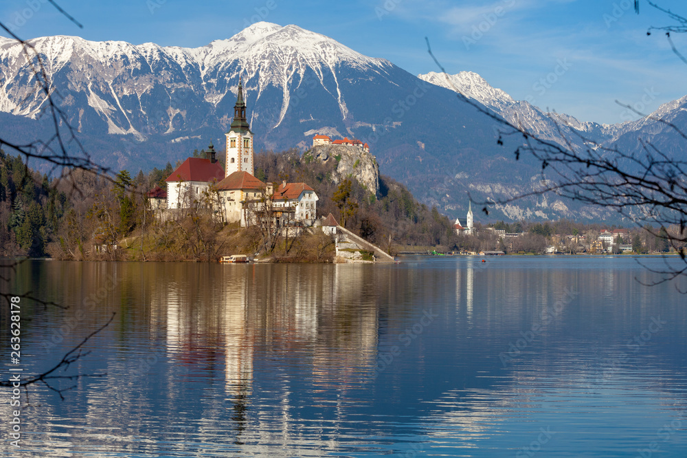 Lake Bled against snowy mountain peaks in early spring. Slovenia, Europe Lake Bled against snowy mountain peaks in early spring. Slovenia, Europe