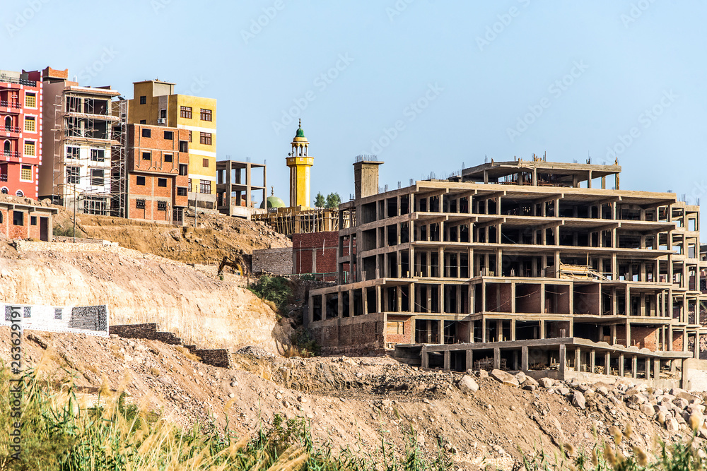 Fototapeta premium Aswan city Egypt panorama view from a boat on the west coast of the Nile on a sunny day