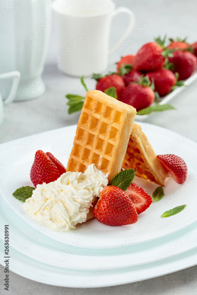 Waffles with strawberries, cream and fresh mint. Waffles with strawberries, cream and fresh mint.