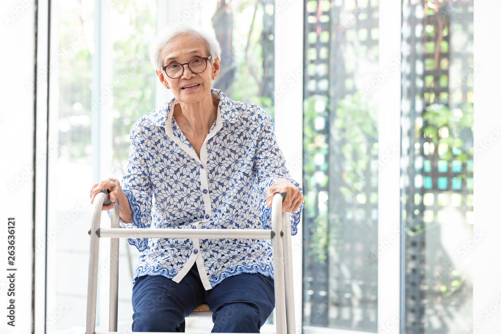 Asian senior woman sitting with walker during rehabilitation, elderly woman  wear glasses,smiling and looking at camera in home Stock Photo | Adobe Stock