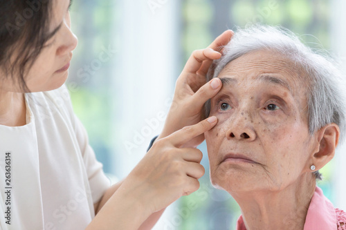 Doctor checking senior woman patient eyes,Ophthalmologist examining eyes of asian elderly woman in clinic,health concept