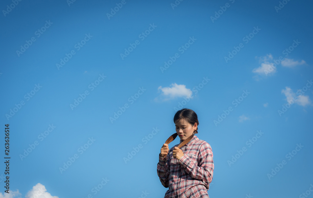 Beautiful portrait woman touching her hair and blue sky background,selective focus. Beautiful portrait woman touching her hair and blue sky background,selective focus.
