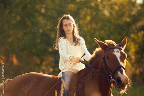 Young girl on the sorrel horse