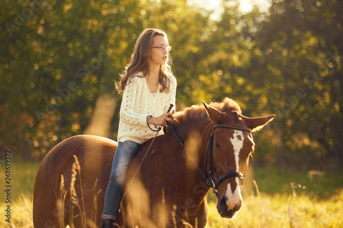 Young girl on the sorrel horse © Olga
