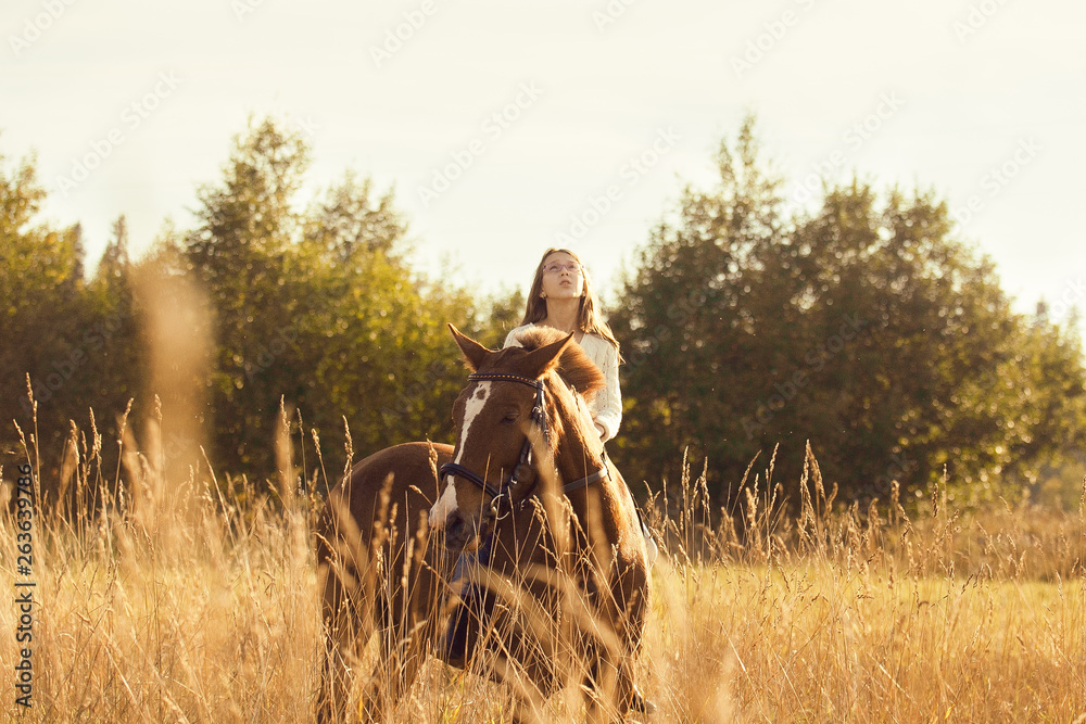 Obraz premium Young girl on the sorrel horse