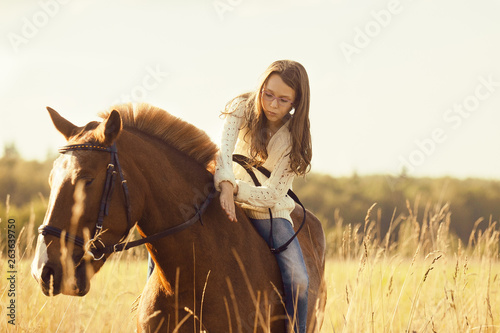 Young girl on the sorrel horse