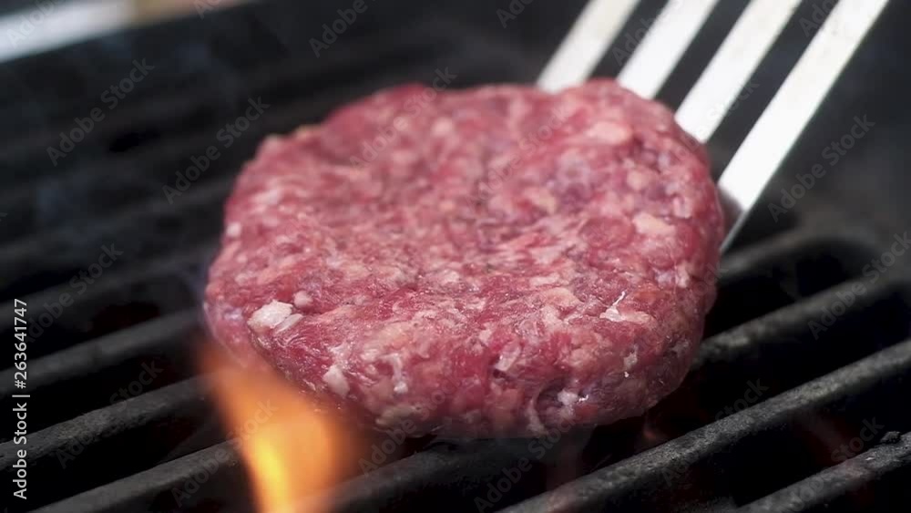 flips Burger meat. slow motion flips Burger meat. slow motion