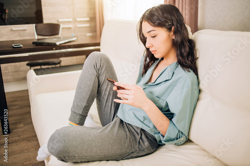 Young woman using smartphone at home