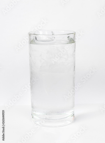  Cold drinking water in a long clear glass with ice cubes inside the glass Isolated on white background