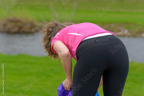 Obraz na plátne Sporty athletic woman bending over