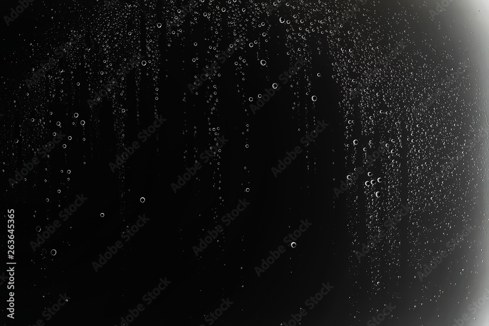 Obraz premium black wet background / raindrops for overlaying on window, concept of autumn weather, background of drops of water rain on glass transparent