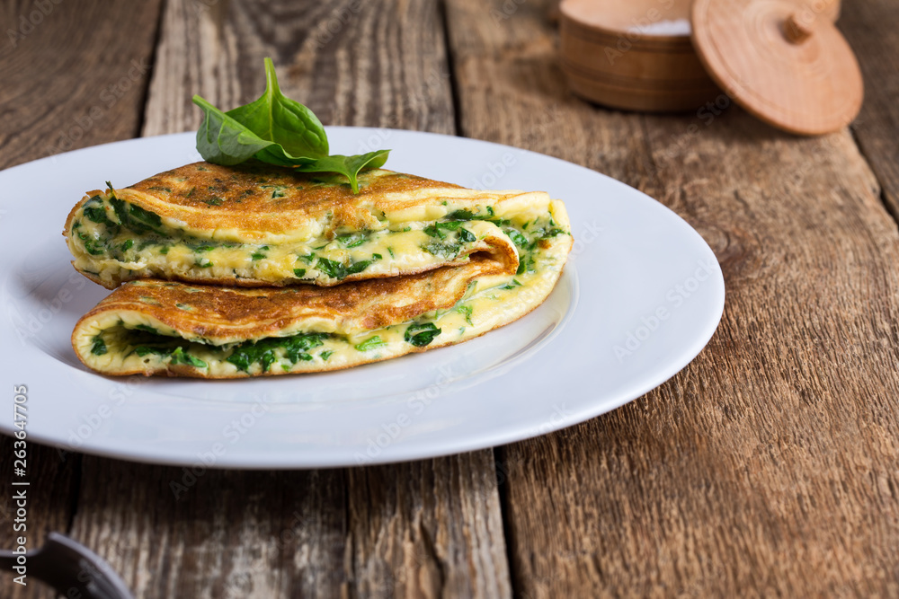 Baby spinach and parmesan cheese omelette, healthy vegetarian breakfast Baby spinach and parmesan cheese omelette, healthy vegetarian breakfast