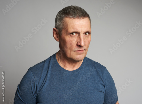 Senior man in blue t-shirt isolated