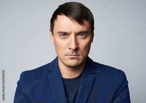 Middle aged handsome man with serious expression on his face